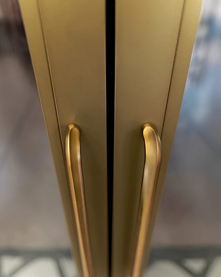 Gold pull handle pair with slim curved grip on double cabinet doors