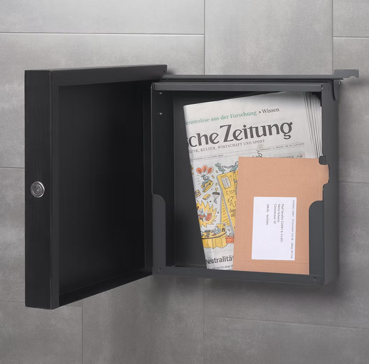 Square black mail post box with open door, holding delivered letters and envelopes